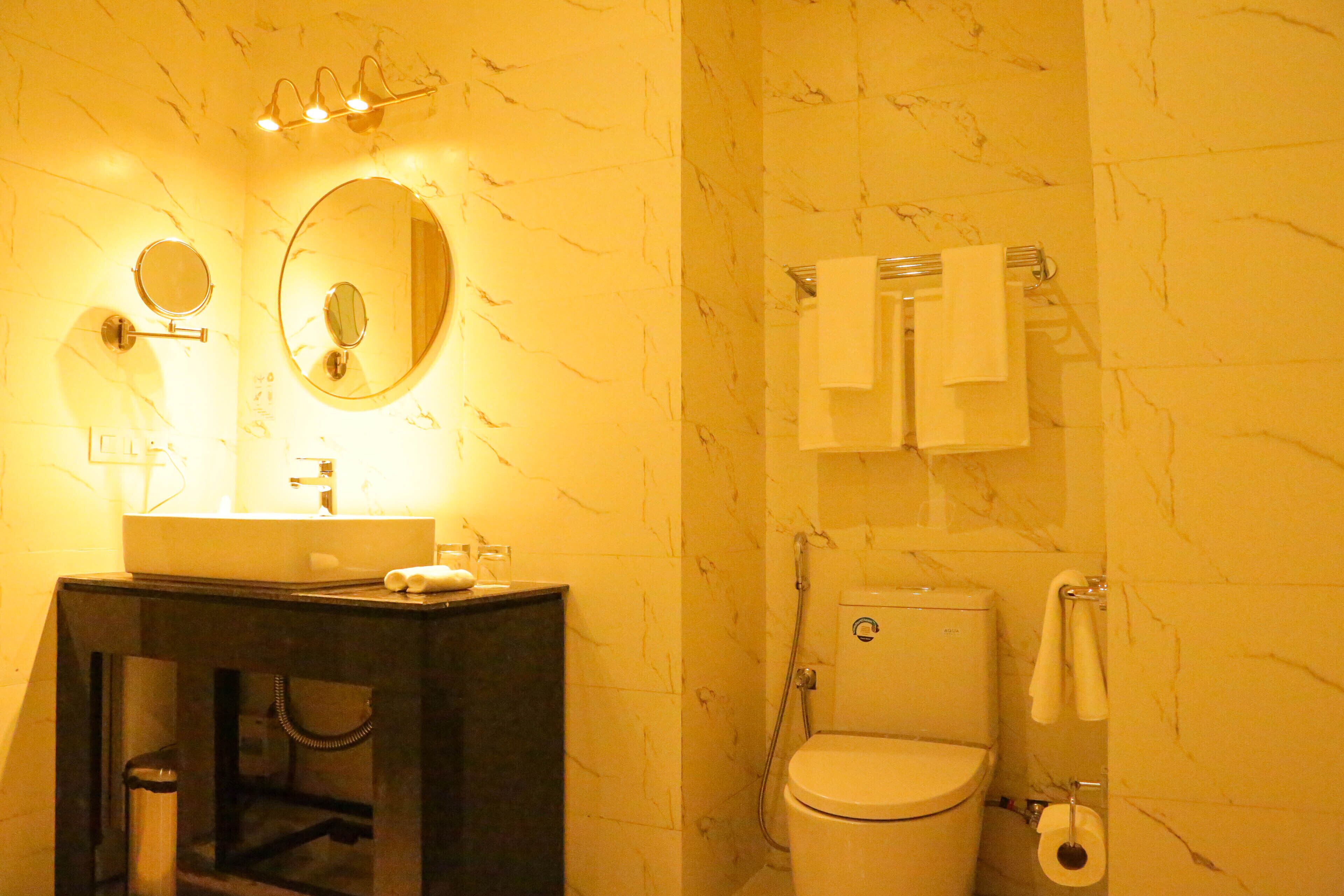 A bathroom with a sink, mirror, and toilet.