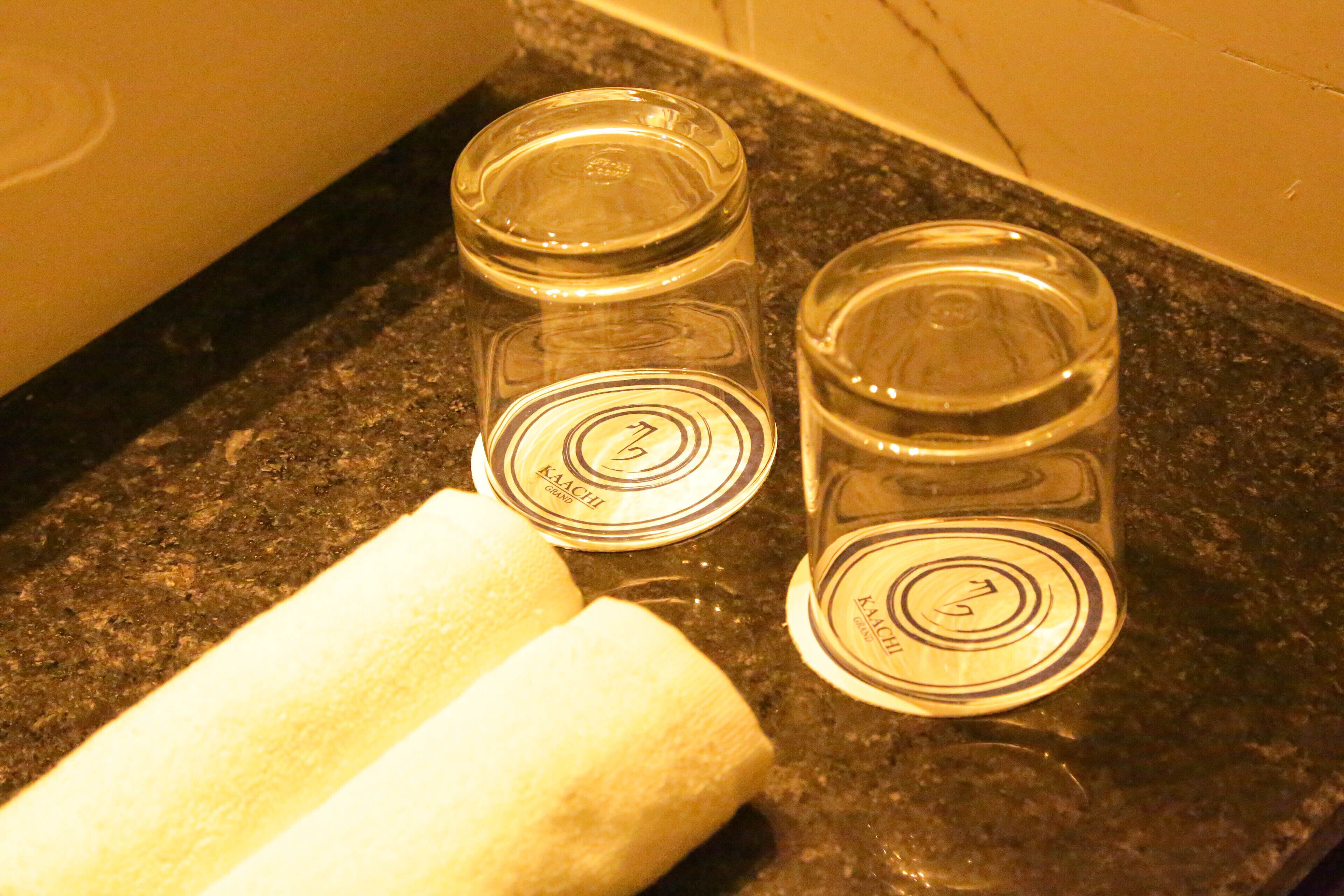 Three glass containers with lids on a dark countertop.