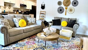 A living room with two sofas, a coffee table, and a patterned rug. - Near Atrium & town, King/Queen/Pullout, NO stairs (Lincolnton)