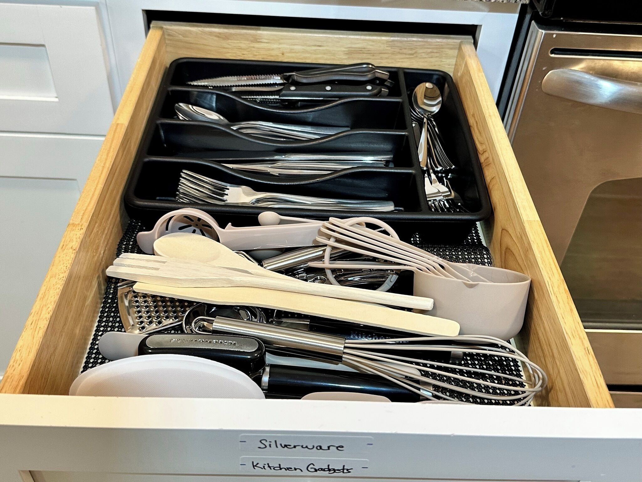 A kitchen drawer with utensils and kitchen gadgets.