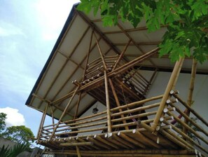 Traditional bamboo structure with a sturdy lattice framework, supported by vertical poles and horizontal beams.