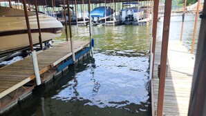 A covered dock area with boats moored underneath. - Osage Beach Condo getaway! (Osage Beach)