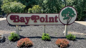 A sign with the text "Bay Point" and a tree silhouette. - Osage Beach Condo getaway! (Osage Beach)