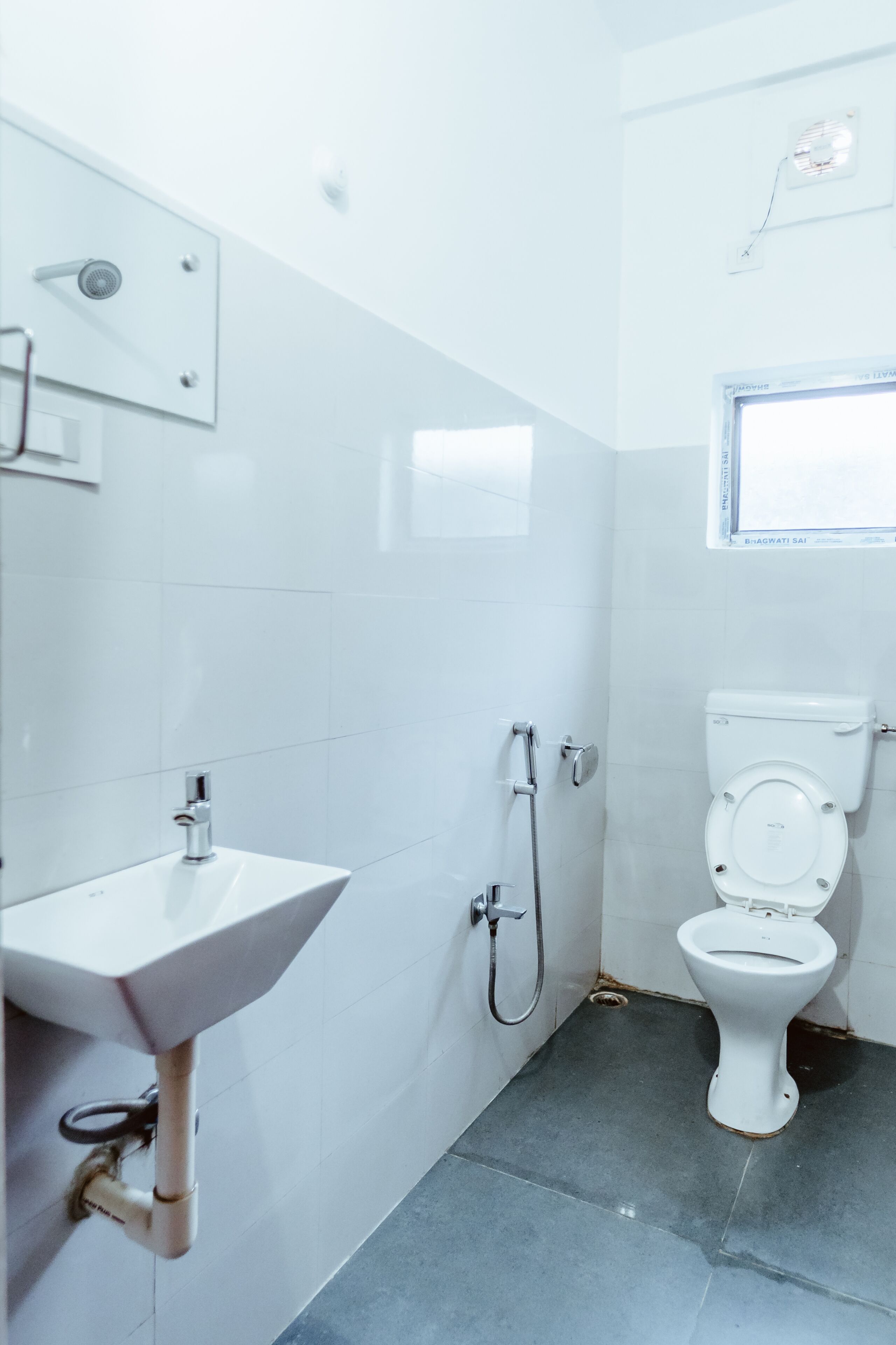 A bathroom with a white sink, a toilet, and a shower.