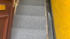 A staircase with carpeted steps leading to a landing. - Corner Shop Apartments Sleeps 5 Parking (Stoke-on-Trent)