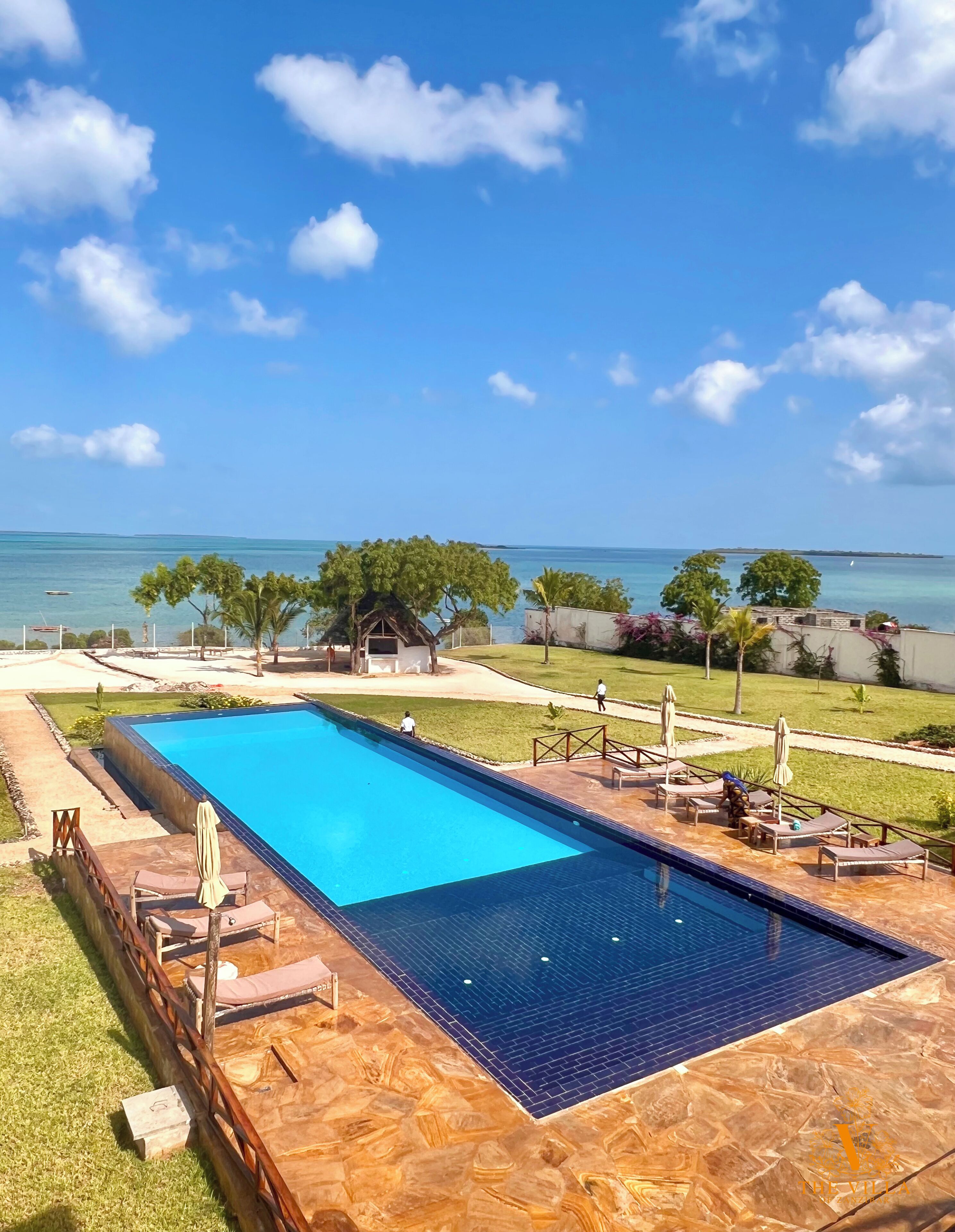 Een buitenzwembad, parasols voor strand/zwembad
