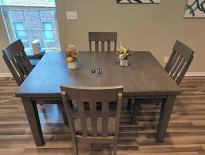 Enjoy meals in this dining area with a table and six chairs, surrounded by a window with a view.