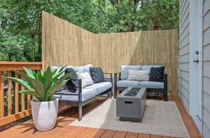 Relax in a serene outdoor space with a comfortable seating area, featuring two sofas and a coffee table.
