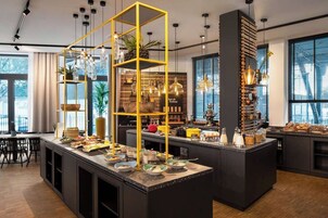 A modern kitchen with a central island, yellow shelving, and various kitchen appliances.