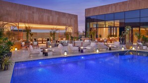 A modern hotel with a pool area, outdoor seating, and a well-lit lounge. - The St. Regis Riyadh (Riyadh)