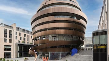 Stunning urban building with a unique, curved design and expansive glass windows.