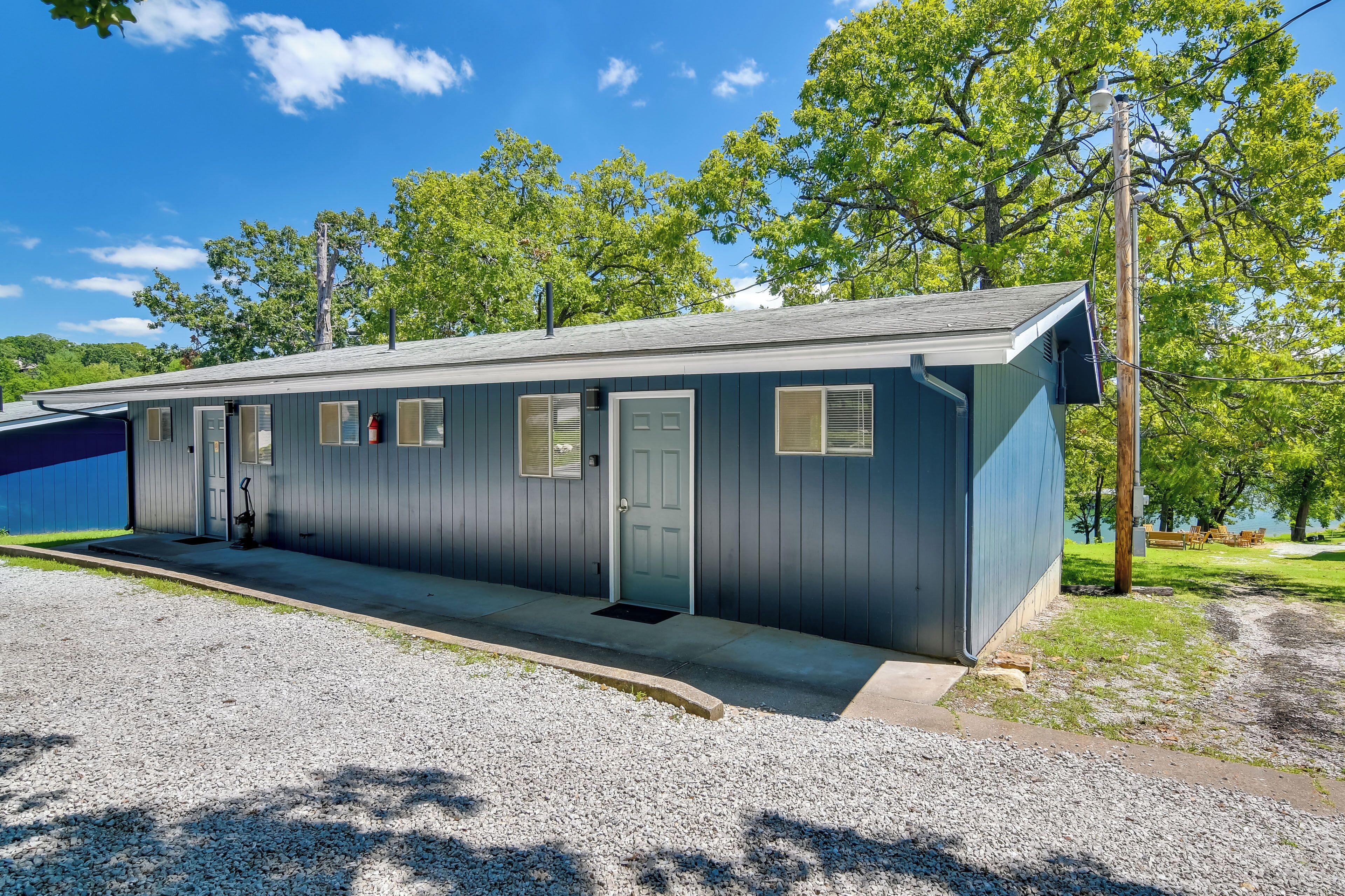 A single-story motel with a gravel driveway and a covered parking area.