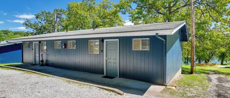 A single-story motel with a gravel driveway and a covered parking area.