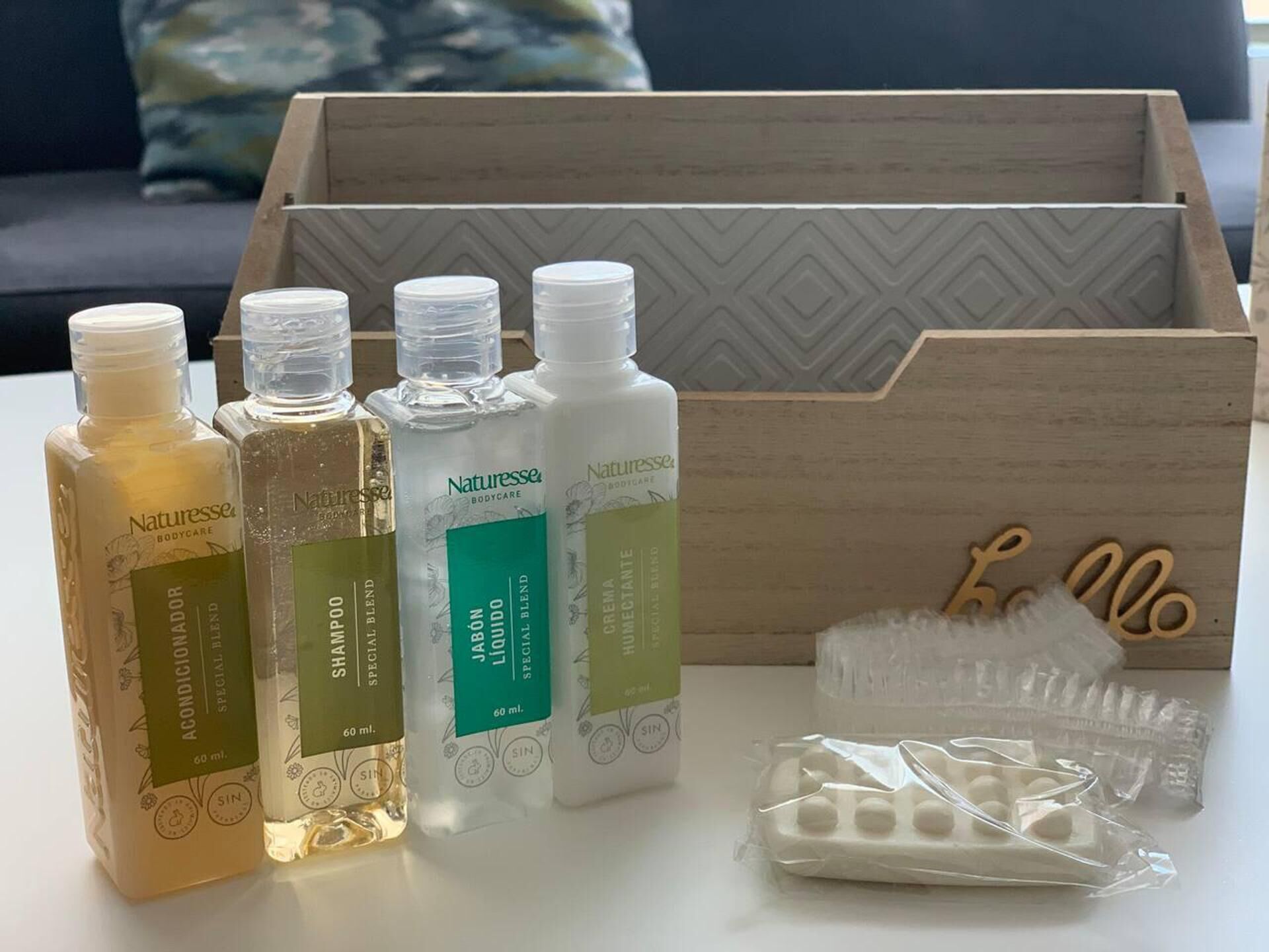 A wooden box containing various Naturelle body care products, including lotions and creams.