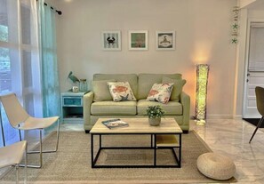 Relax in this inviting living space with a sofa, coffee table, and floor lamp.