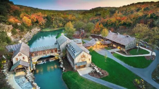 A resort with a river, multiple buildings, and a well-maintained lawn. - Cozy Condo - Table Rock Lake Community in Hollister, MO (Hollister)