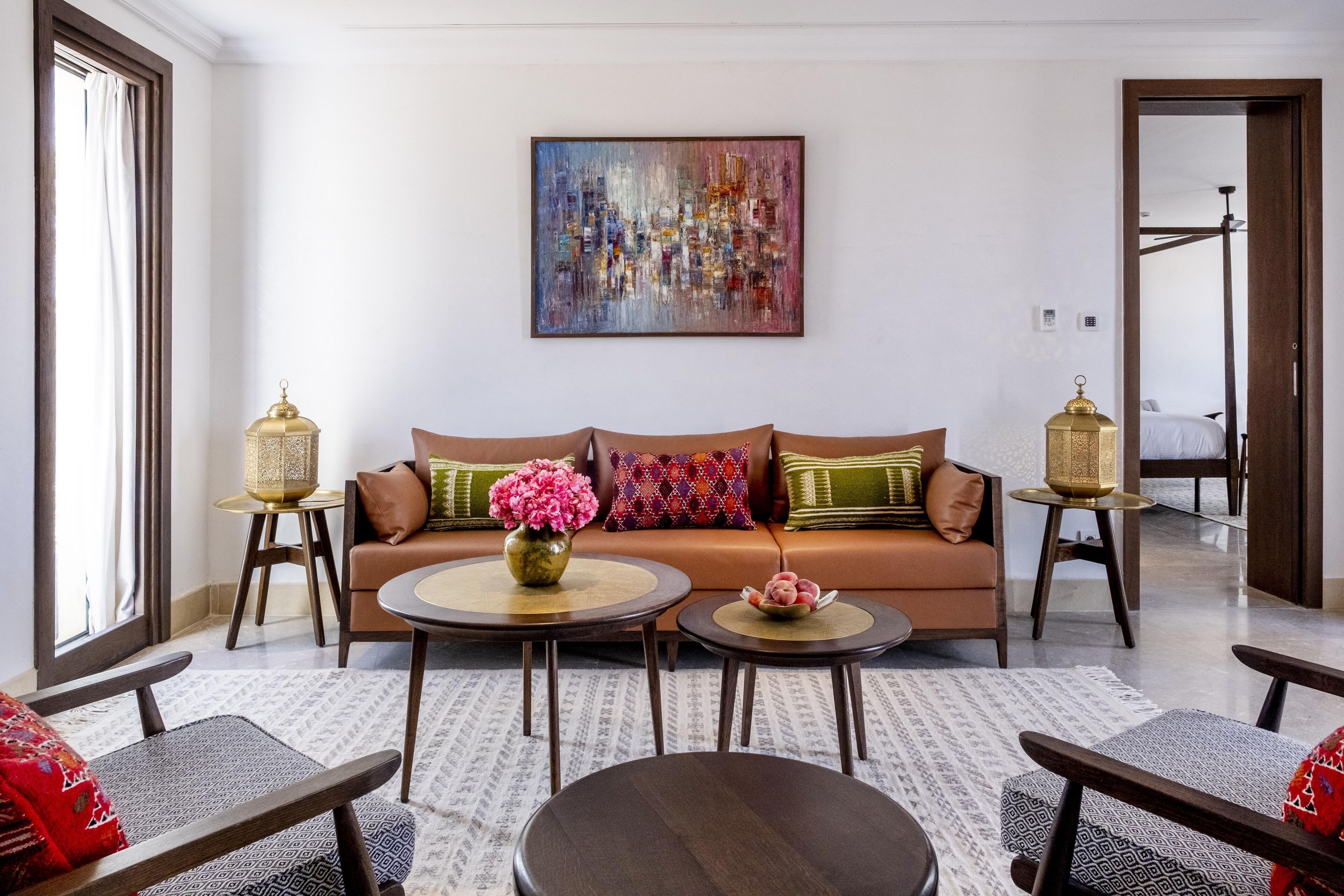 A modern living room with a sofa, two side tables, and a coffee table.