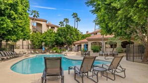 A swimming pool area with lounge chairs and palm trees. - Biltmore Condo w/ Heated Pool! (Phoenix)
