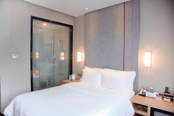 A modern hotel room with a large bed, a glass shower enclosure, and bedside lamps. - Lavande Hotel Shenzhen University city Metro Station (Shenzhen)