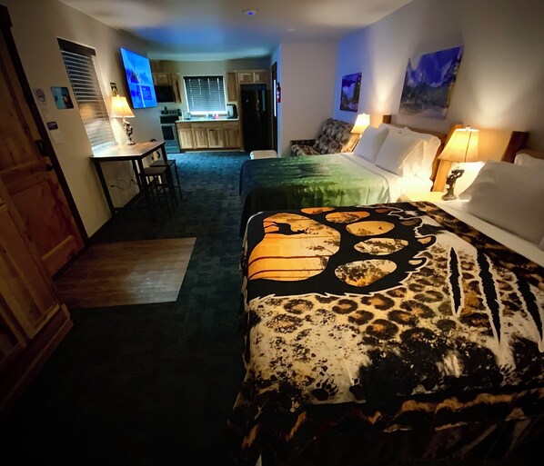 A hotel room with a bed, a desk, and a kitchenette. - Bear Mountain -Suite 7 (Grants Pass)