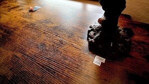 A wooden table with a bear statue and a USB drive. - Bear Mountain -Suite 8 (Grants Pass)