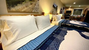 A hotel room with a large bed, a desk, and a kitchenette. - Bear Mountain -Suite 8 (Grants Pass)