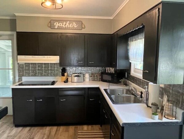 Enjoy cooking in this well-equipped kitchen with an oven and sink.