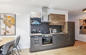 Fridge, stovetop, dishwasher, coffee/tea maker
