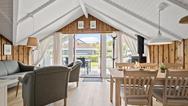 A cozy attic room with a dining area, a sofa, and a fireplace. - Amazing home in Hejls with WiFi (Hejls)