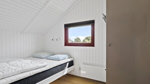 A bedroom with a single bed, a window with a red frame, and a white radiator. - Amazing home in Hejls with WiFi (Hejls)
