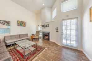 Relax in this inviting living room with a large sofa, coffee table, and fireplace.