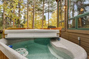 A hot tub with a wooden deck, surrounded by trees. - Hot Tub & Ski Shuttle: Rustic Breckenridge Retreat (Breckenridge)