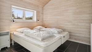 A bedroom with a bed, a nightstand, a window, and a wooden ceiling. - Gorgeous home in Glesborg with WiFi (Glesborg)