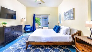 A hotel room with a bed, a TV, a desk, a chair, and a balcony with a view. - 25% Off Sep 3-6! Perfect 4 Families -Pool, Jacuzzi (Palm Springs)