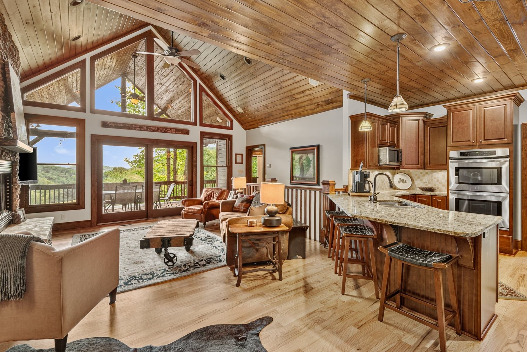 A spacious living area with a large window, a fireplace, and a cozy seating arrangement.