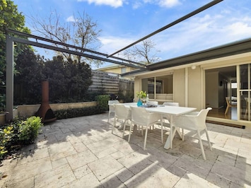 Enjoy outdoor dinners in this beautiful space surrounded by lush greenery and a gas BBQ.