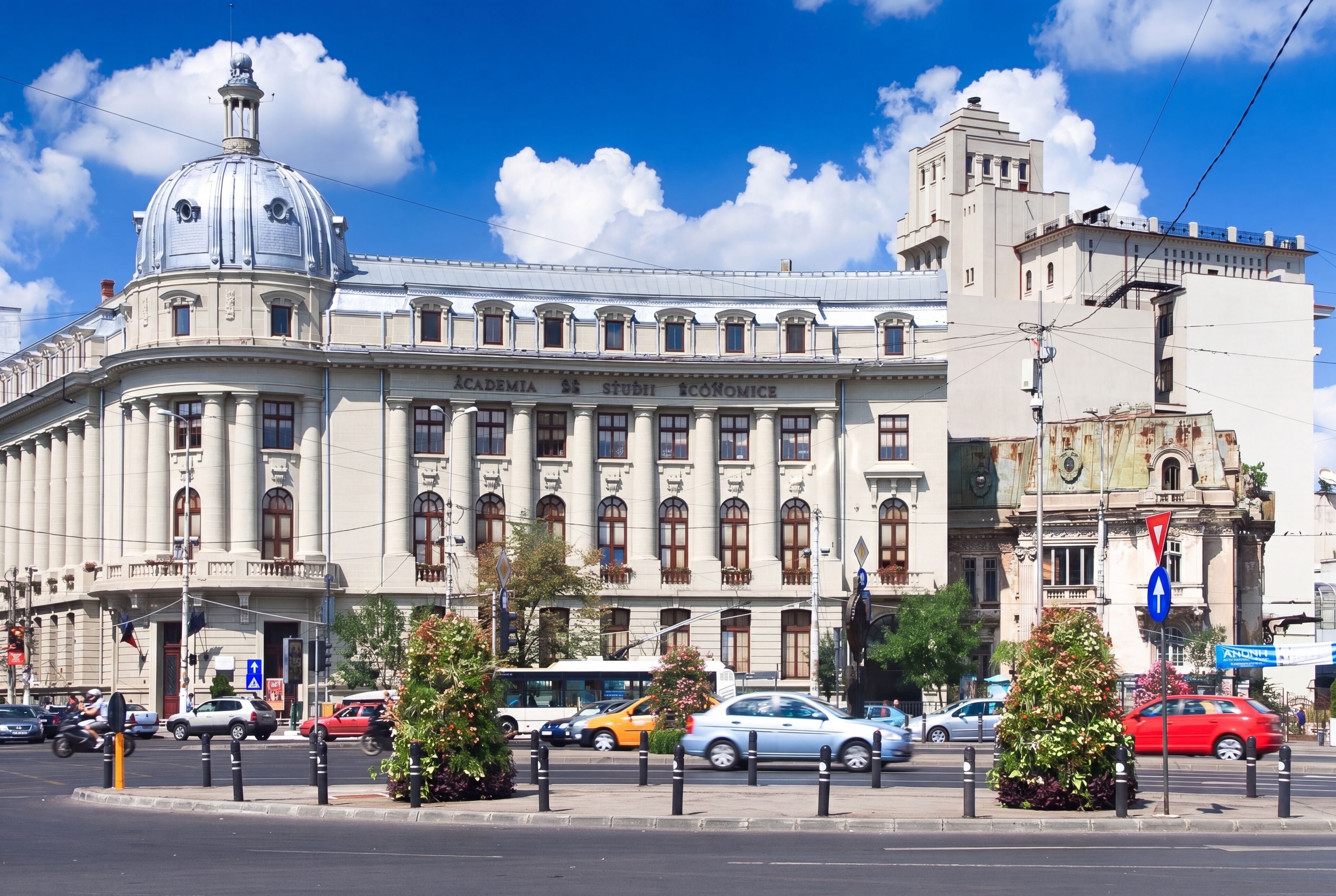 A historic building with a prominent dome and classical architecture, featuring a large entrance and multiple windows.