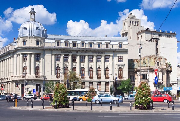 A historic building with a prominent dome and classical architecture, featuring a large entrance and multiple windows.