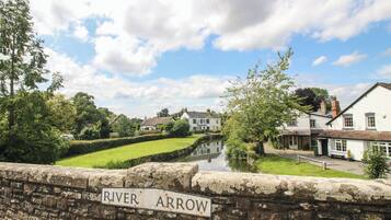 A stone bridge with a sign reading "River Arrow."