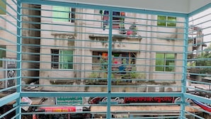 A balcony with a metal railing overlooking a street scene. - Mohammadia Restaurant & Guest House (Dhaka)