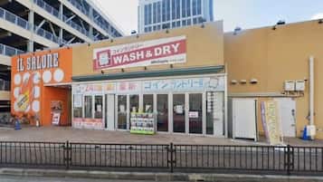 A commercial building with a 'WASH & DRY' sign and a 'IL SALONE' sign.