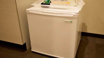 A white refrigerator with a label reading "HERB Relief".