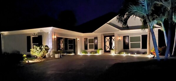 Stunning two-story building with a central entrance and beautifully manicured lawn.