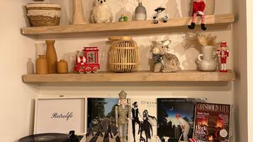 A shelf with various decorative items including a small train, a book titled "Retrodlife," and a vinyl record player.