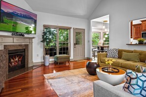 A living room with a fireplace, a television, a sofa, and a coffee table.
