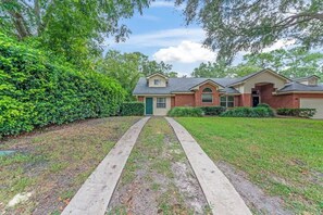 A residential house with a front yard, a driveway, and a garage.