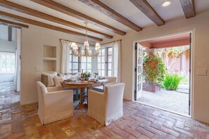 Enjoy meals in this cozy dining area with a wooden table and four comfortable chairs.