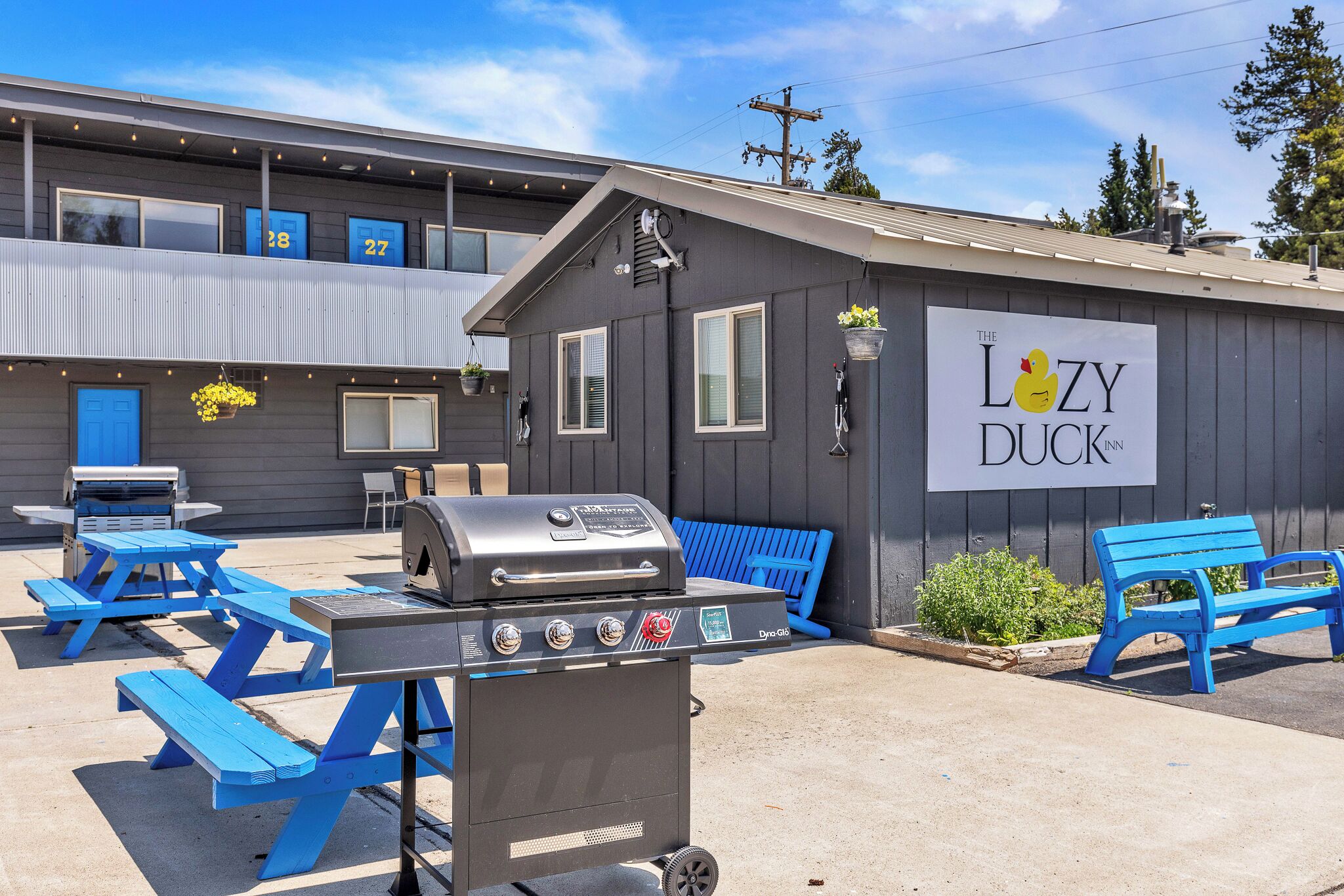 Outside patio with benches, tables and grills