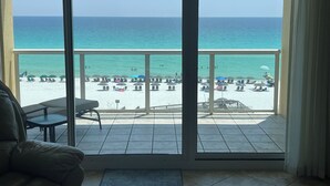 A balcony with a view of a beach and ocean. - Gulf Front Resort w/Pools. 2 chairs/umbrella included for your stay! (Navarre)