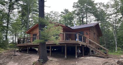 Timber cottage with large deck overlooking the water. Boat access only, no road.